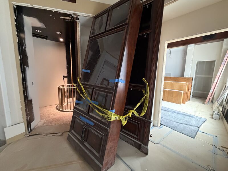 Built-in cabinetry being removed from a home for a building component donation